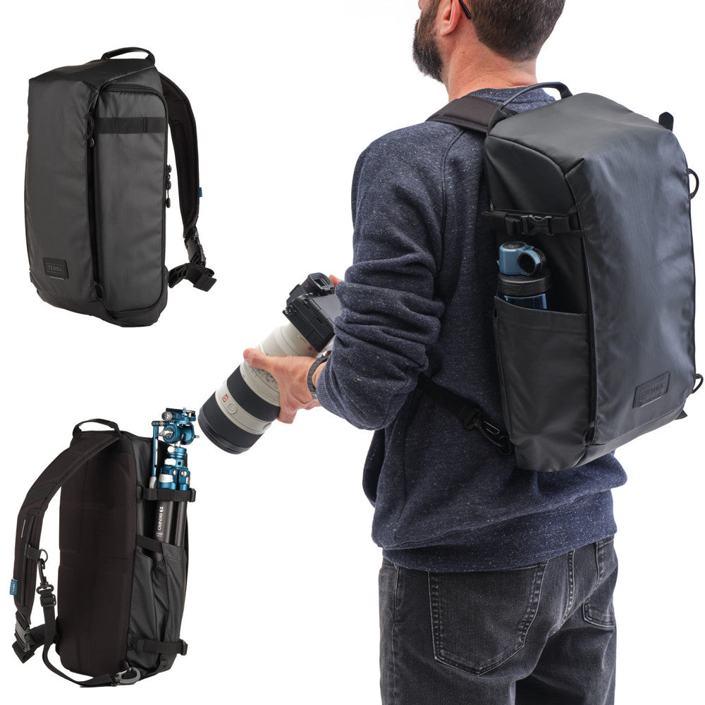 Man holding a camera with a backpack on a white background