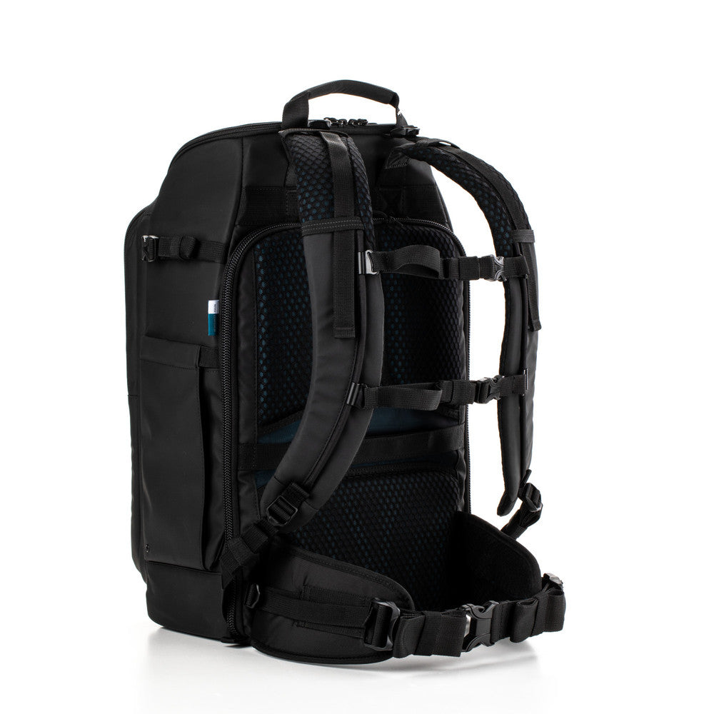 Black backpack with multiple compartments and straps on a white background