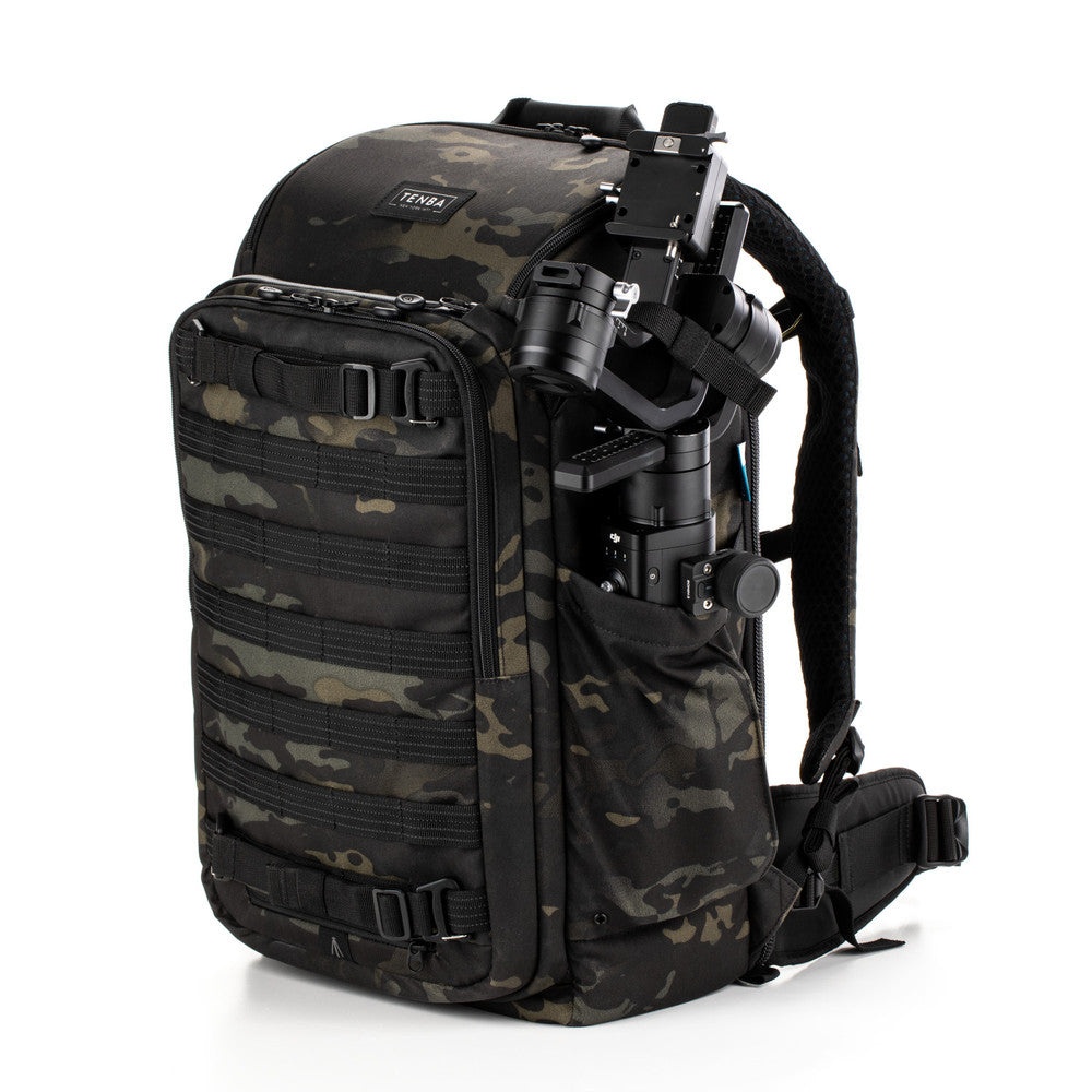 Camouflage backpack with tactical equipment on a white background