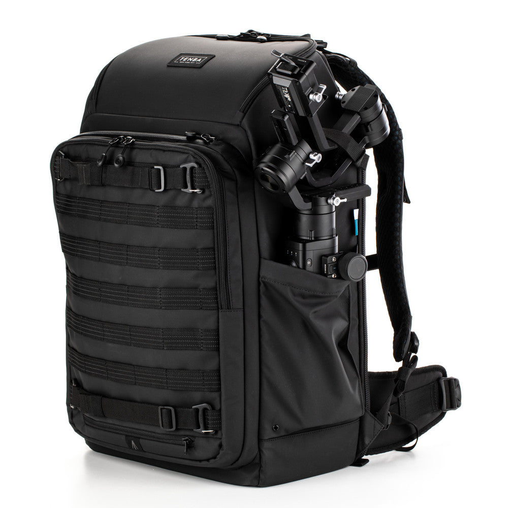 Black backpack with camera equipment on a white background