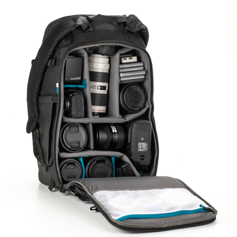 Camera backpack with compartments filled with camera equipment on a white background