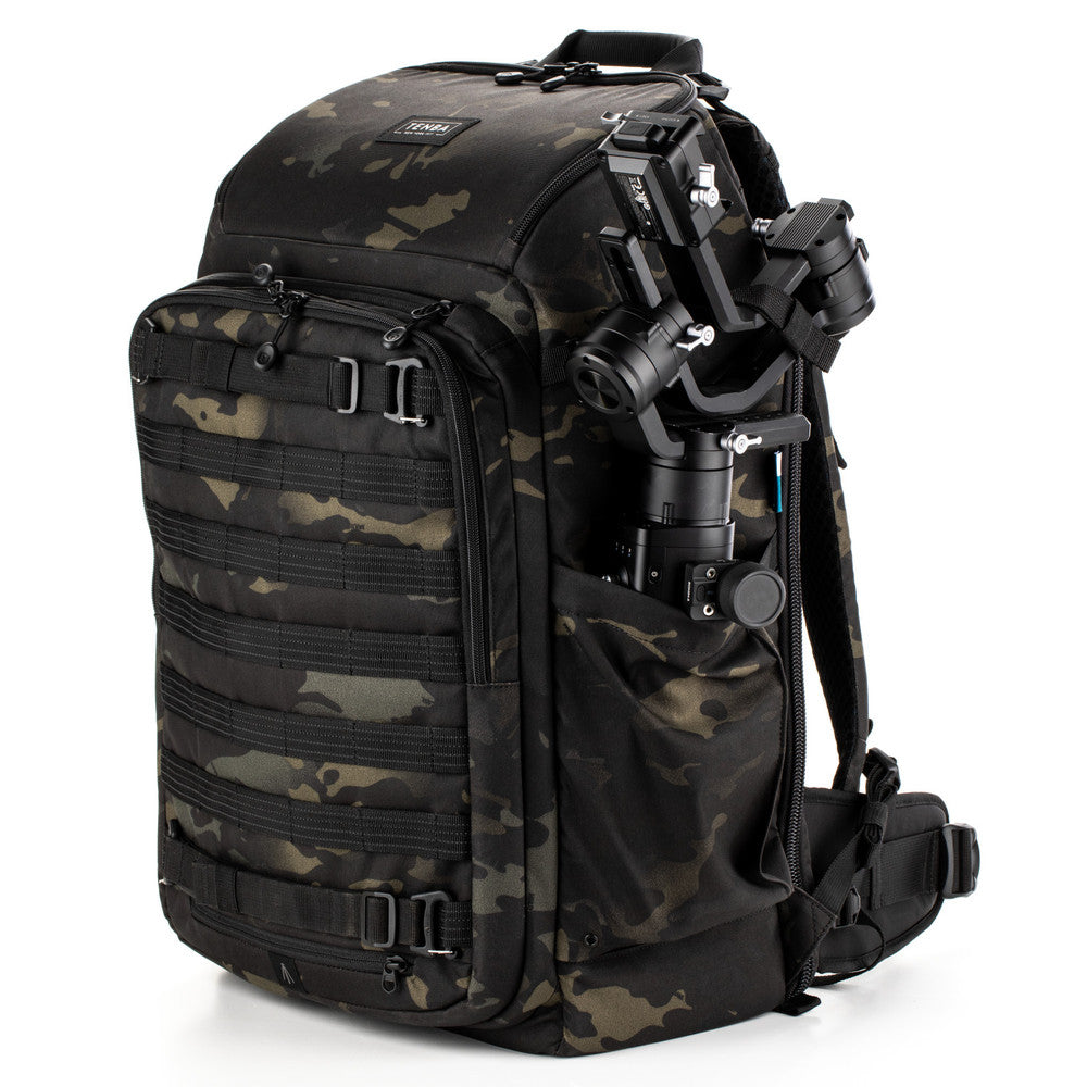 Camouflage backpack with camera equipment on a white background