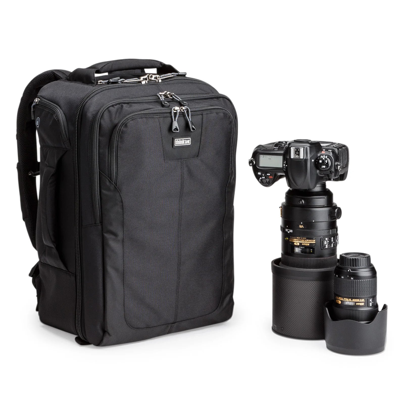 Think Tank Airport Commuter camera backpack — black carry-on bag with padded camera compartment, laptop sleeve, and side tripod straps.