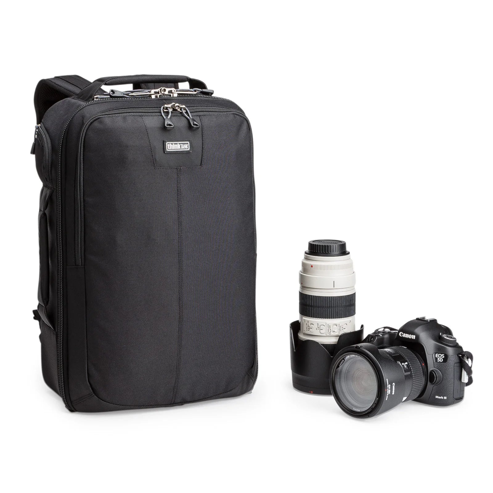 Think Tank Airport Essentials camera backpack — compact carry-on size black pack with front organizer pocket, grab handles, and laptop sleeve