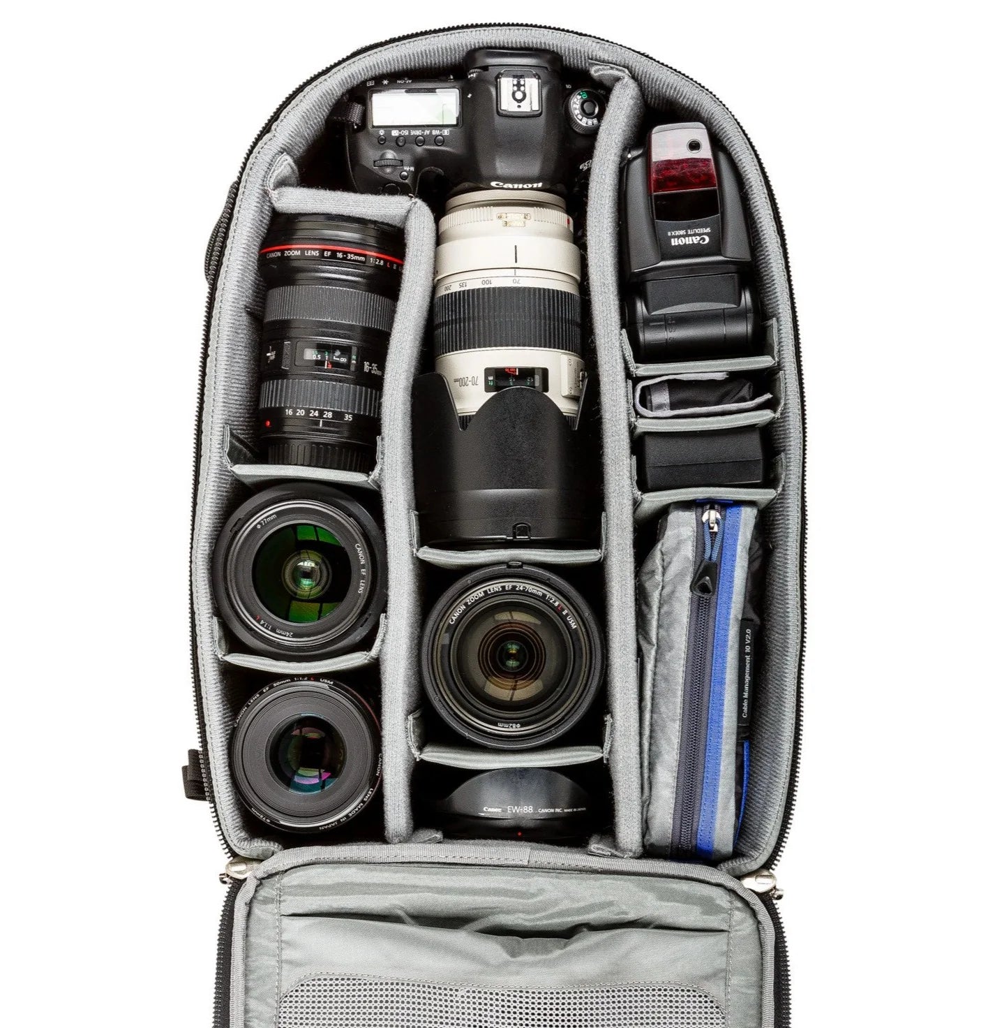 Think Tank Airport Essentials camera backpack — compact carry-on size black pack with front organizer pocket, grab handles, and laptop sleeve