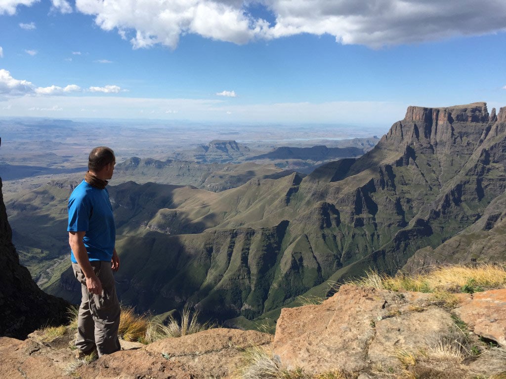 Man hiking in the Drakensberg, looking over mountains