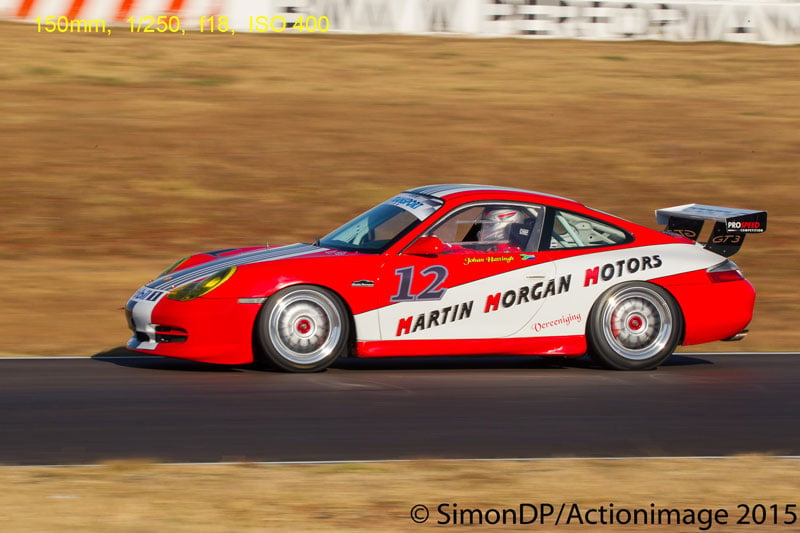 Photograph of moving Porsche 911 GT3 with blurred background