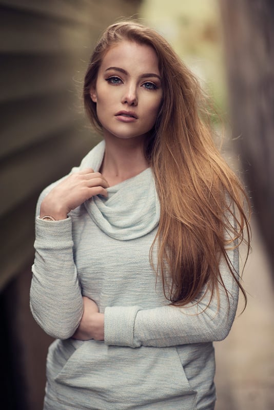 Girl with grey long sleeve standing in alley