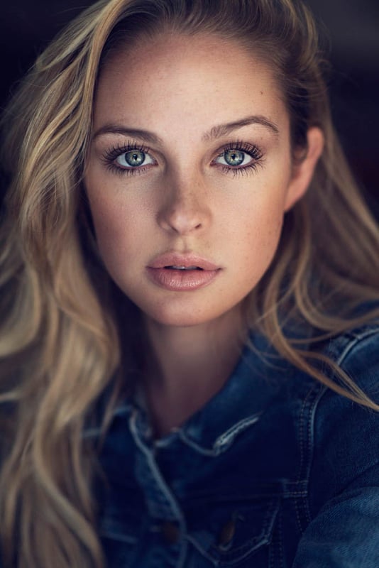 Girl with blond hair and denim jacket