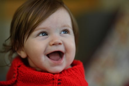 Smiling baby photographed with 105mm