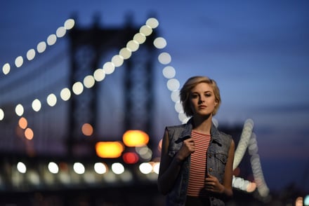 Young woman on bridge at nigh photographed with Nikon 105mm