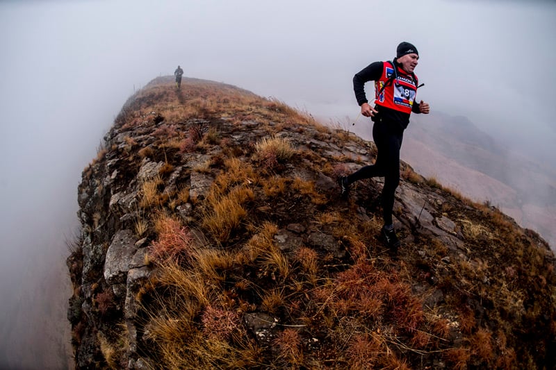 A photograph of a trail runner on a misty mountain taken by Craig Kolesky