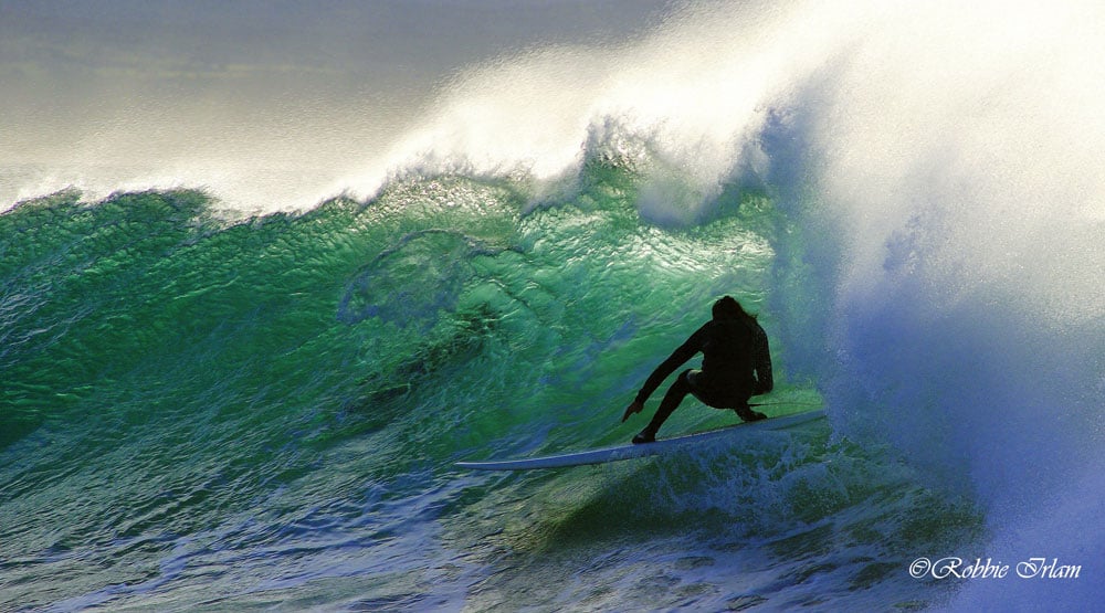 a surfer in the barrel of a wave