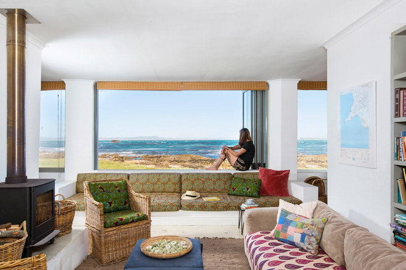 Photograph taken from the inside of a house from the living room looking out toward the ocean
