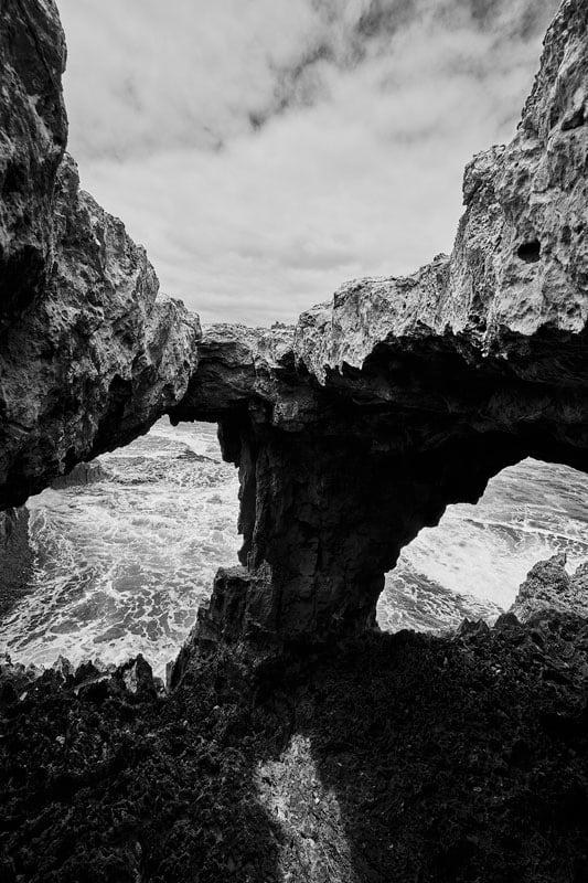 Black and white landscape through holes in rocks
