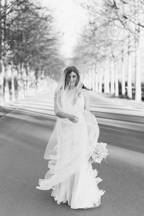 A photograph of a bride strutting her stuff down the road