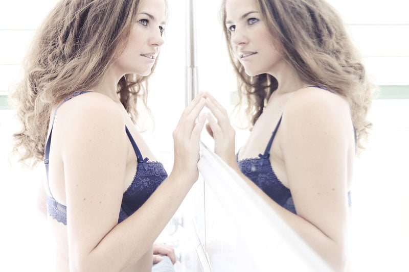 boudoir image of woman in front of mirror