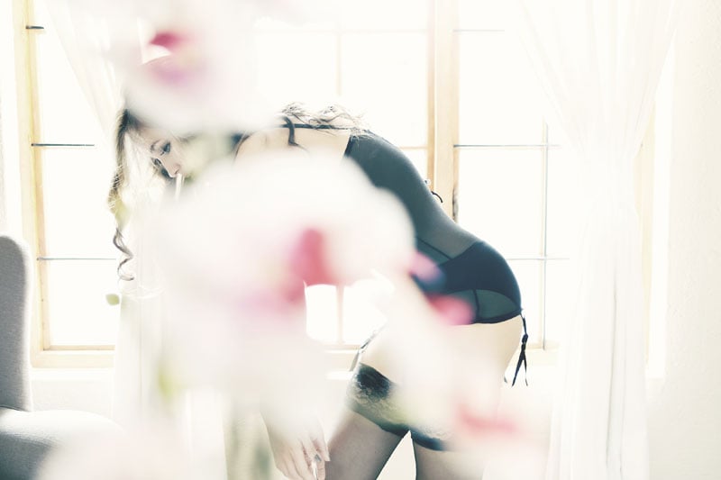 boudoir image with blurred out flowers