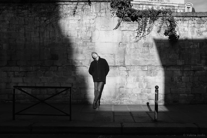 Valerie Jardin photographs a man Leaning against a wall in Paris
