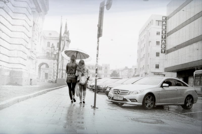Film Photography taken by Jk Zorgman of two women walking in the rain in Karstadt