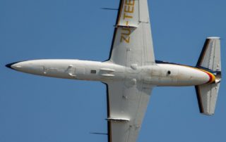 the underside of an aeroplane fly at a 90-degree angle