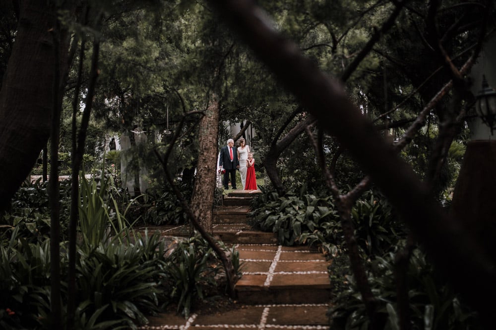 A bride walking down a rainy aisle by Blanche B Photography
