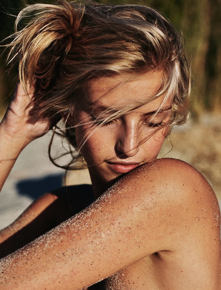 Portrait photograph of model on the beach by Sherwin Liang