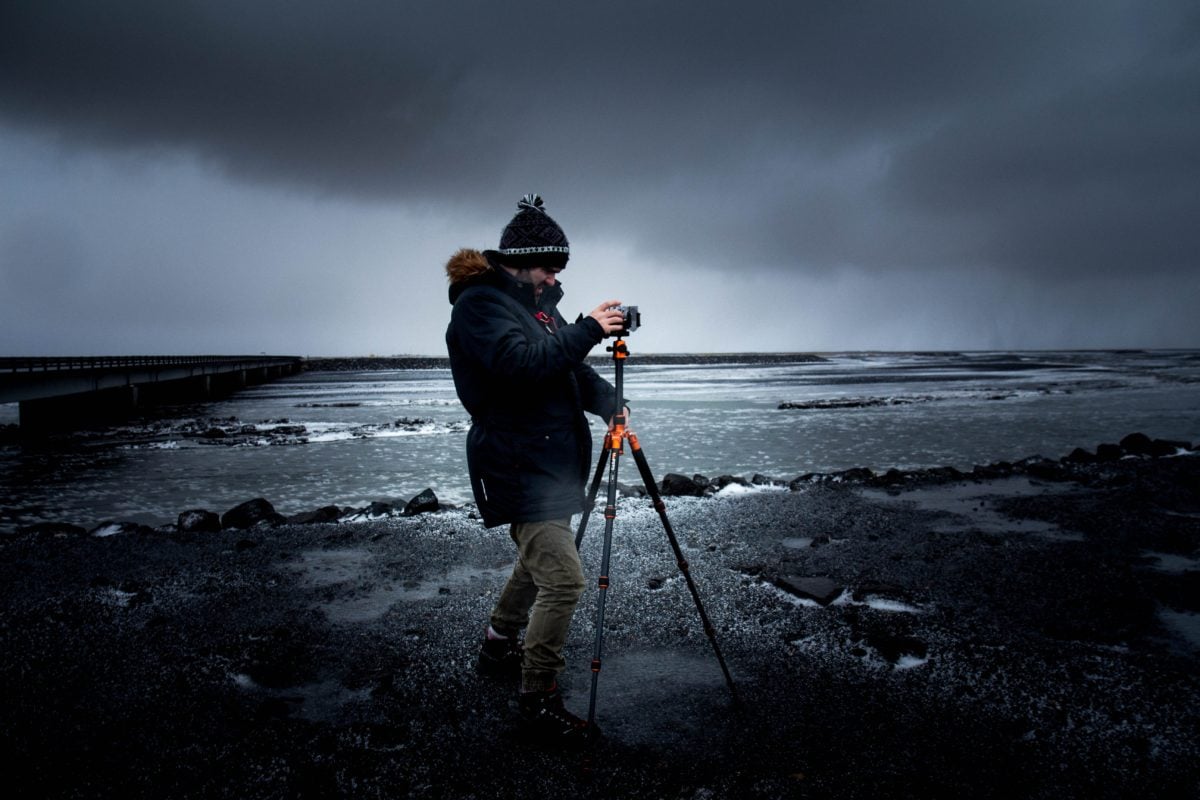 Man with tripod taking seascapes.
