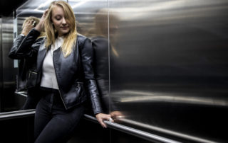 Photograph of woman in black in elevator using Canon RF 35mm f/1.8 Lens by Gunther Swart