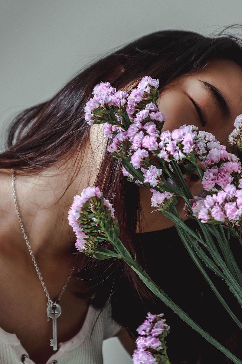 Portrait Creative portrait of a woman with flowers in front of her face