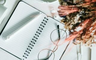 Notebook and glasses flatlay