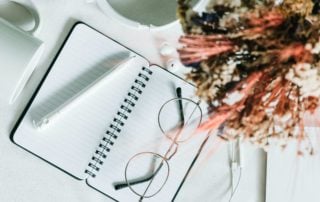 Notebook and glasses flatlay