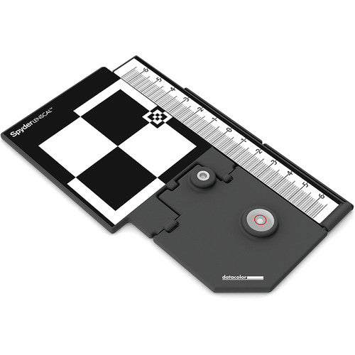 Spyder LENSCAL color calibration device with checkered pattern and ruler on a white background