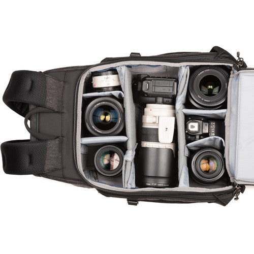 Think Tank Urban Access 15 camera backpack — black pack with side-loading panels, rear entry flap, and front tripod strap.