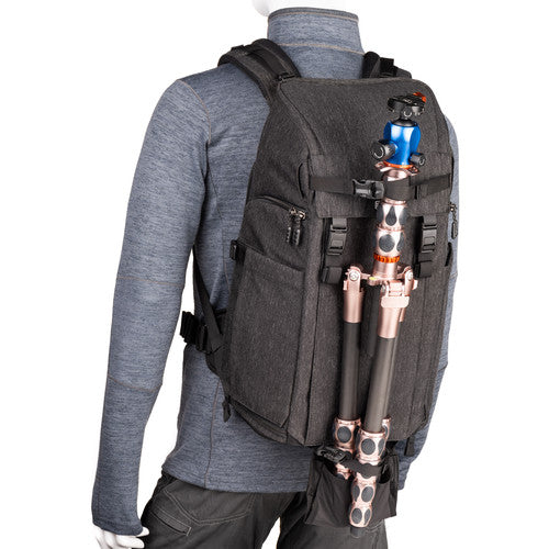 Think Tank Urban Access 15 camera backpack — black pack with side-loading panels, rear entry flap, and front tripod strap.