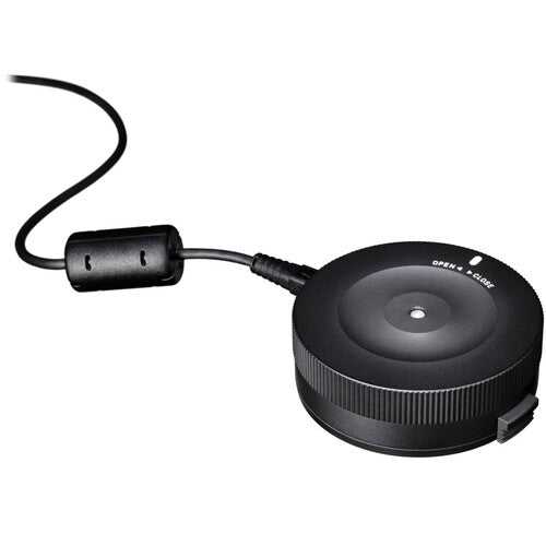 Sigma USB Dock for Nikon F-mount lenses enabling firmware updates, autofocus calibration, and customization of focus speed, focus limiters, and optical stabilization via Sigma Optimization Pro software.