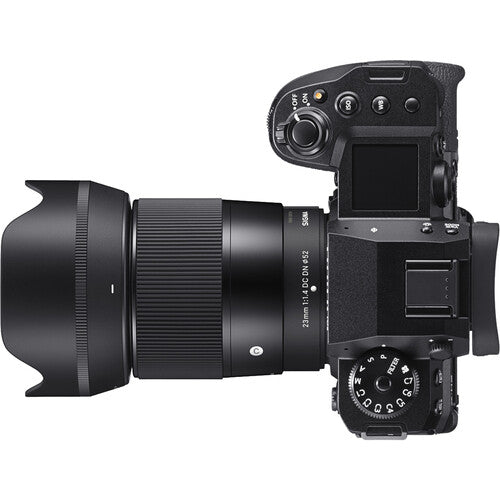 Sigma 23mm f/1.4 DC DN Contemporary wide-angle prime lens for APS-C mirrorless cameras featuring bright f/1.4 aperture, advanced optics with SLD and aspherical elements, compact lightweight design, and quiet high-speed autofocus.