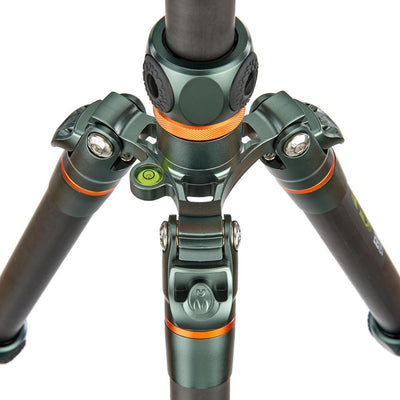 Close-up of a green and black tripod with orange accents on a white background
