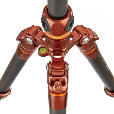 Close-up of a red and black tripod on a white background