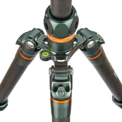 Close-up of a camera tripod with green and black color scheme on a white background