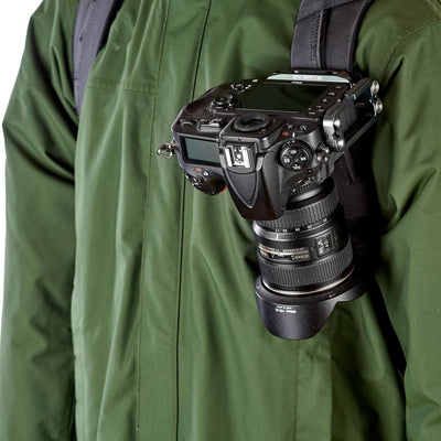Camera attached to a person wearing a green jacket