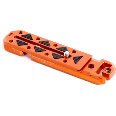 Orange metal bracket with black triangular patterns on a white background