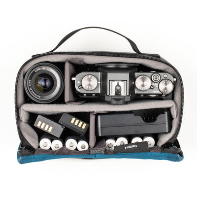 Camera bag with compartments for camera equipment and accessories on a white background