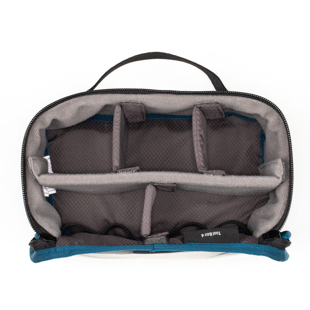 Gray toiletry bag with blue interior on a white background