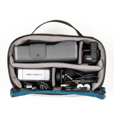Pouch containing electronic devices and accessories on a white background