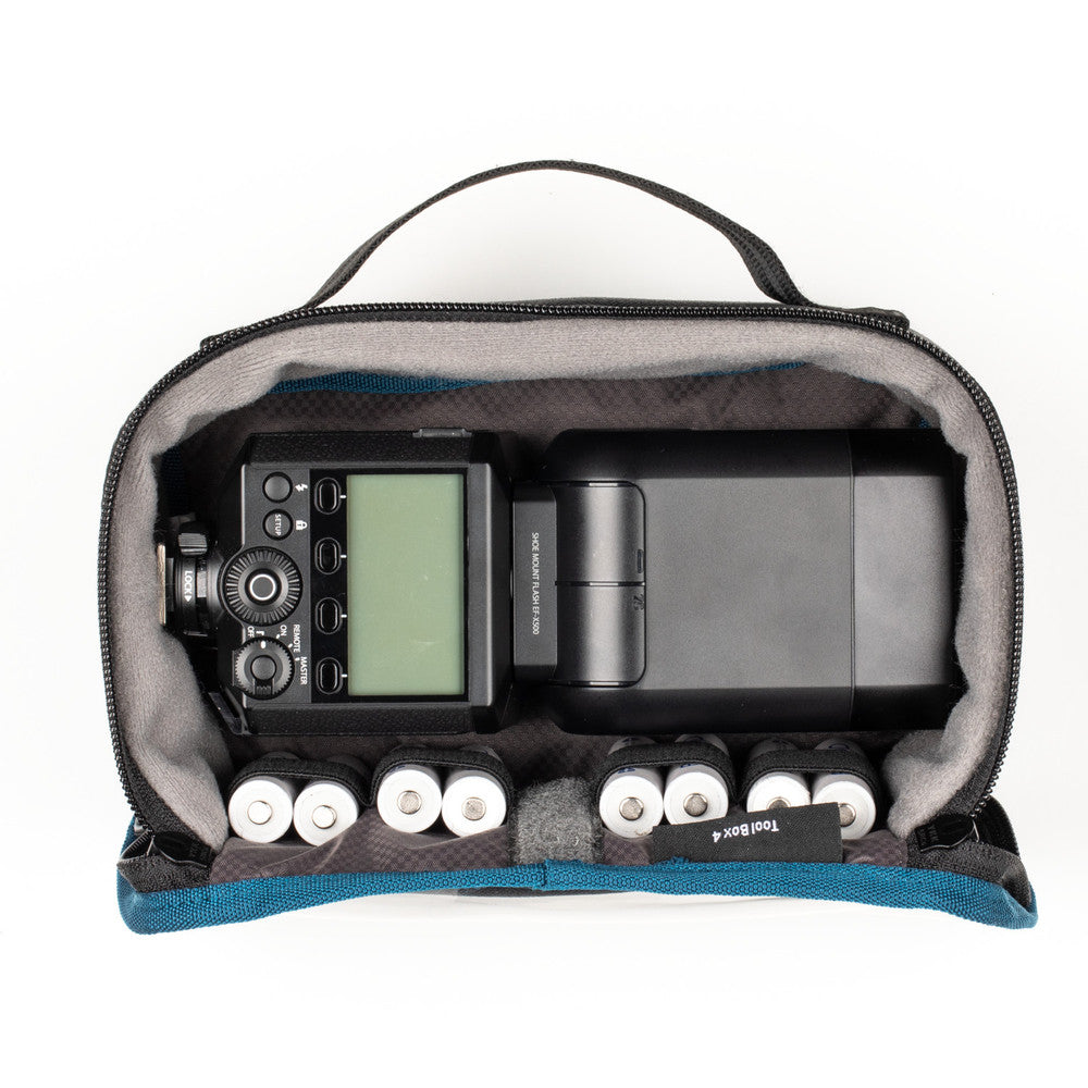 Camera and flash equipment inside a carrying case on a white background