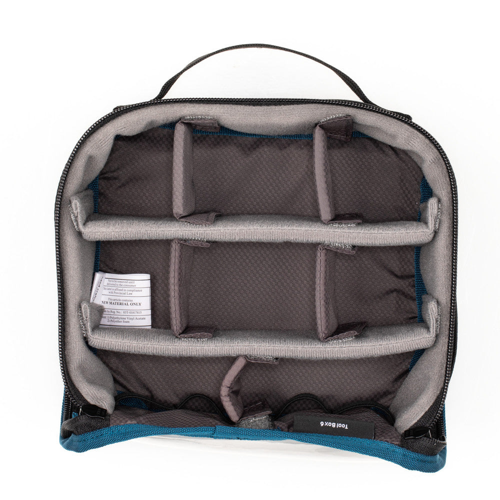 Open travel bag with compartments on a white background