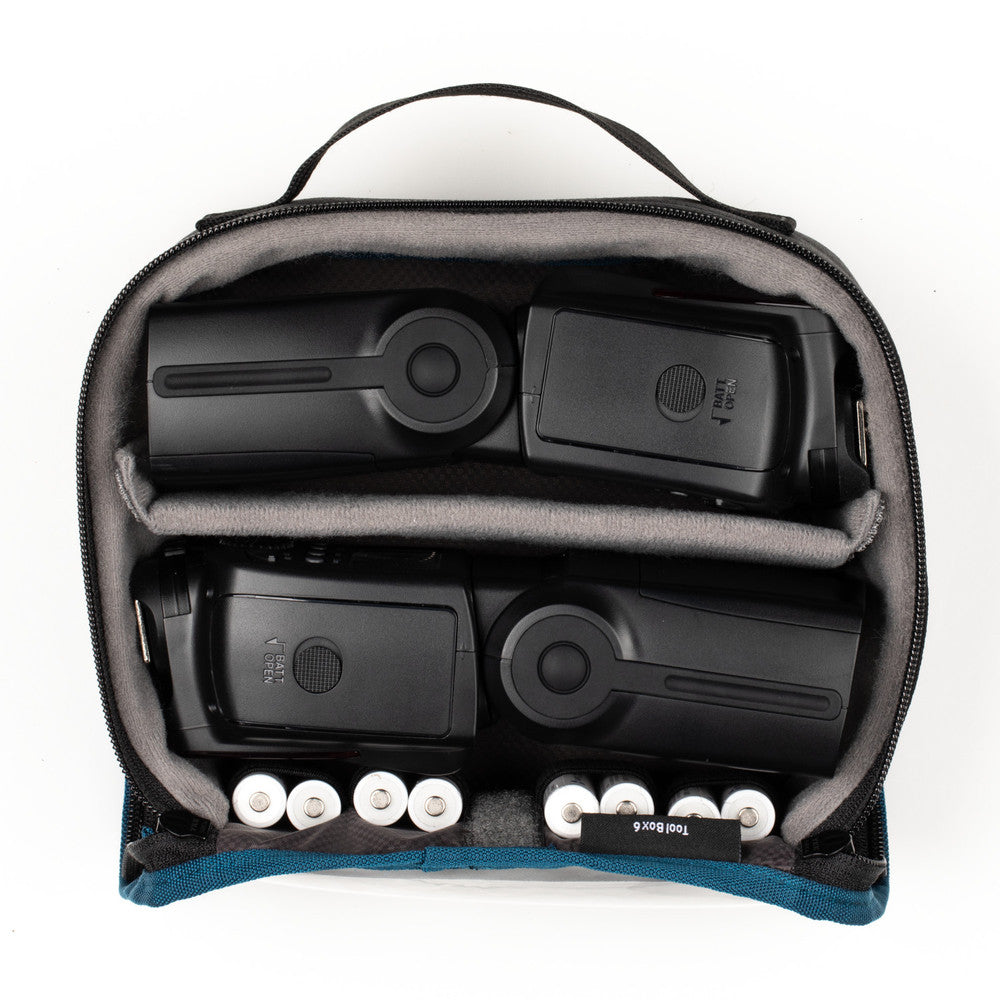 Black electronic devices in a gray carrying case on a white background