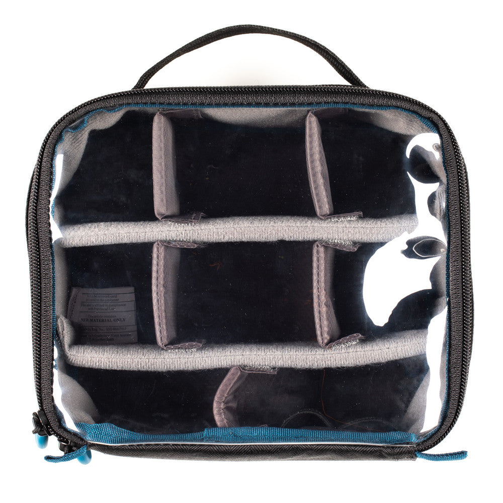 Clear travel bag with black interior compartments on a white background