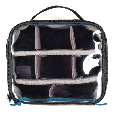 Clear travel bag with black interior compartments on a white background